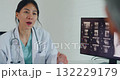 Young Asia female doctor with old man patient use clipboard for consulting, advice and medical expert at desk in health clinic office. Help, appointment support in hospital for diagnosis, physician. 132229179