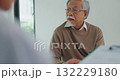 Young Asia female doctor with old man patient use clipboard for consulting, advice and medical expert at desk in health clinic office. Help, appointment support in hospital for diagnosis, physician. 132229180