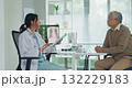 Young Asia female doctor with old man patient use clipboard for consulting, advice and medical expert at desk in health clinic office. Help, appointment support in hospital for diagnosis, physician. 132229183