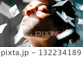 Portrait of a woman with closed eyes surrounded by flying papers, symbolizing stress relief, contemplation, or creative inspiration 132234189