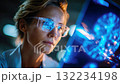 Focused doctor examining digital brain scan on transparent screen, representing neurology, advanced diagnostics, and medical research 132234198