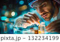 Man in traditional attire examining perfume bottles, representing craftsmanship, culture, and luxury fragrance creation 132234199