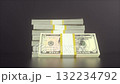 Stacked Bundles of Five Dollar Bills on Dark Minimalist Background 132234792