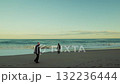 Two Distant Men Walk to Relax Their Minds Near the Stormy Waves Ocean 132236444