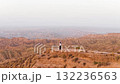 Muslim woman standing victoriously on a canyon cliff overlooking the desert 132236563