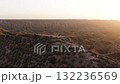 Hiker enjoying the stunning sunset view from mountain top 132236569