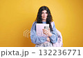 Student using smartphone and holding notebooks on yellow background 132236771
