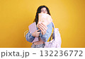Happy student showing canadian dollars on yellow background 132236772
