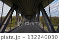 Cycling beneath historic Grosshesseloher Bridge Grosshesseloher Bruecke in Munich, Germany. Discover scenic views, bike-friendly routes and charm of Isartal on peaceful ride. Cycling infrastructure 132240030