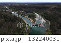 Aerial view of the VLH hydropower plant Baierbrunn at the Isar River, near Munich, Germany. Rest water energy, fish ladder, eco-friendly electricity, scenic landscape, renewable energy in Bavaria 132240031