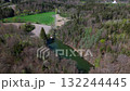 Drone shot of Spiegelweiher, fish pond chain in Grafing bei Muenchen, Bavaria, Germany. This hidden gem near Munich features quiet hiking trails, reflective waters and vibrant spring greenery  132244445