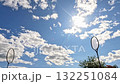 Badminton racket under bright sun and cloudy sky 132251084