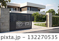 A gray private house of two floors hidden behind a fence with automatic sliding brown gates 132270535