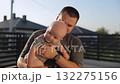 Caring young father plays with adorable baby son in cottage house backyard 132275156