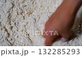 Hand makes a hole in which he will throw the egg for the genuine dough 132285293