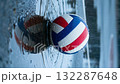 Volleyball slowly rolls across the puddle on a rainy day 132287648