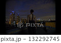 Beautiful young woman in black suit the night on the roof of down town building 132292745