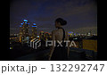 Beautiful young woman in black suit the night on the roof of down town building 132292747