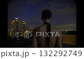 Beautiful young woman in black suit the night on the roof of down town building 132292749