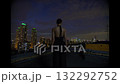 Beautiful young woman in black suit the night on the roof of down town building 132292752