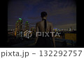 Beautiful young woman in black suit the night on the roof of down town building 132292757