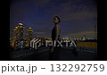 Beautiful young woman in black suit the night on the roof of down town building 132292759