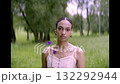 Beautiful young woman in pretty with blue flowers in her hand in park, summer 132292944