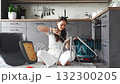 Frustrated young woman trying to assemble a chair with tools on the floor. Concept of difficulty and struggle in do it yourself project. 132300205
