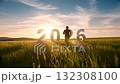 Silhouettes of people running towards 2026 on a grassland at sunrise 132308100