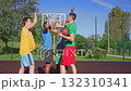 Motivated athletic fit diverse multi ethnic male basketball players with ball giving high five , showing unity,team spirit, good sportsmanship and readiness before streetball game on outdoor court. Motivated athletic fit diverse multi ethnic male basketball players with ball giving high five , showing unity,team spirit, good sportsmanship and readiness before streetball game on outdoor court. 132310341