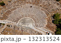 Aerial top view of the ancient amphitheater in Bodrum, Turkey. Historic stone structure and semicircular design showcase ancient architecture under bright sunlight. 132313524