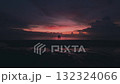 Aerial shot couple in love enjoying romantic evening on beach by sea against beautiful sunset background. Woman in love rests her head on man's shoulder and they enjoy romantic vacation by sea sunset 132324066