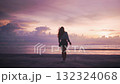 Happy young woman with arms outstretched twirling and enjoying beautiful tropical pink sunset on beach inspired woman enjoying tropical paradise beach vacation and beautiful sunset. Happiness concept. 132324068