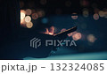 Close up of businessman hands using smartphone at night, with blurred city lights creating bokeh effect in background, suggesting late night work or communication. Gadgets in business 132324085