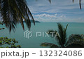 Tropical sea view framed by palm trees. Lush palm trees frame breathtaking view of serene turquoise ocean, with distant islands adding to idyllic tropical paradise scene under beautiful sky 132324086