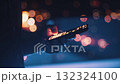 Chatting on phone about work late at night. Businessman using smartphone at night, surrounded by vibrant city lights creating stunning bokeh effect in background, typing messages and browsing internet 132324100