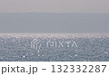 Beautiful sparkling sun reflections on light blue water surface. Continuously changing wavy sea surface with horizon for background. Neutral mirror effect, sun glittering around on the beach. 132332287
