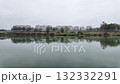 Typical old panel apartments on a foggy winter day. Block houses on the Csepel Island in Budapest, Hungary. There are beautiful water reflections in the foreground on the surface of the River Danube. 132332291