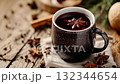 Warm mulled wine with spices in a cozy setting during winter festivities 132344654