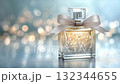 Elegant perfume bottle adorned with a ribbon captured in soft lighting during a festive celebration 132344655