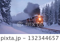 Train travels through snowy forest landscape in winter with smoke billowing from its engine at dusk 132344657