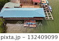 A beautiful aerial view of a colorful coastal village with water bound homes showing the harmony between human life and the calm sea environment 132409099