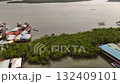 A beautiful aerial view of a colorful coastal village with water bound homes showing the harmony between human life and the calm sea environment 132409101