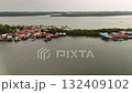 A beautiful aerial view of a colorful coastal village with water bound homes showing the harmony between human life and the calm sea environment 132409102