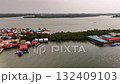 A beautiful aerial view of a colorful coastal village with water bound homes showing the harmony between human life and the calm sea environment 132409103
