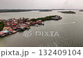 A beautiful aerial view of a colorful coastal village with water bound homes showing the harmony between human life and the calm sea environment 132409104