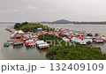 A beautiful aerial view of a colorful coastal village with water bound homes showing the harmony between human life and the calm sea environment 132409109