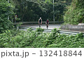 young asian couple cycling outdoors on rural road	 132418844