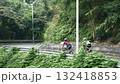 rear view of two female cyclists training on rural road	 132418853