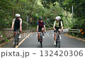 three happy and cheerful young asian cyclist friends riding bicycles on rural road	 132420306